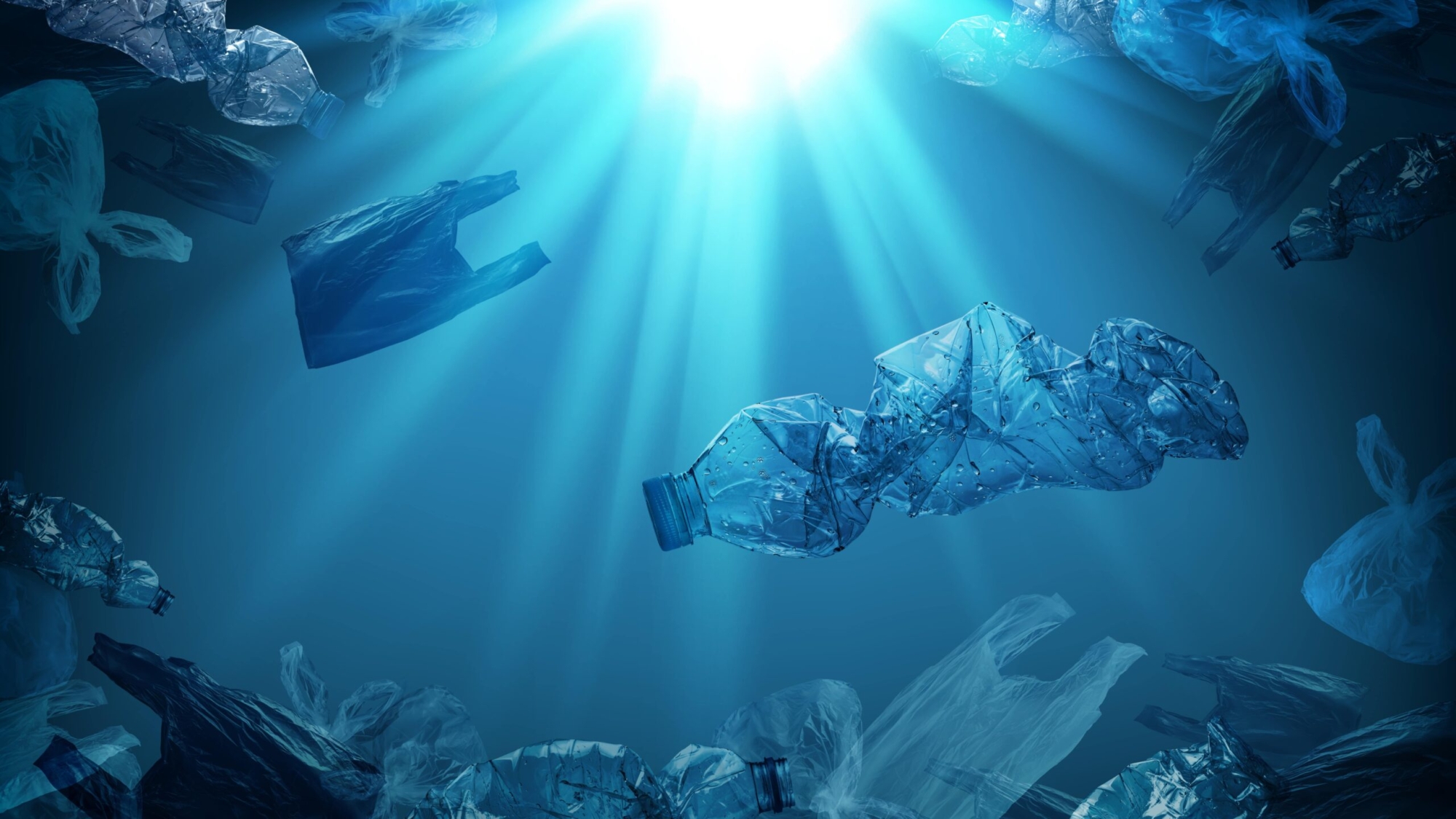 pet-plastic-bottles-single-use-plastic-bags-floating-sea-ocean-with-rays-sunlight-min